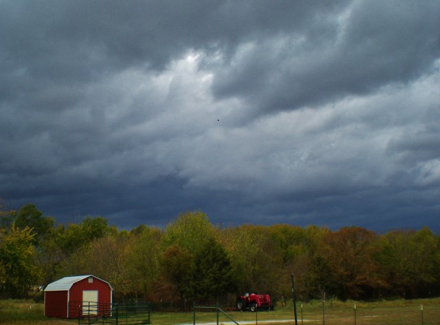 Storm clouds with red barn at a Northeast Texas Homestead. #TexasHomesteader