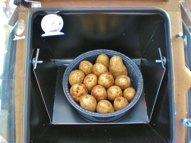 Cooking potatoes in a solar oven outside. 5 Frugal Things - Easy ways we saved money this week. Plants for the garden, tree removal costs, home haircuts and more. Come see. #TexasHomesteader