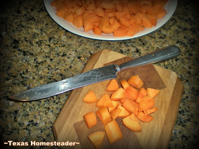 Chopping fresh carrots in preparation for a meal or dehydrating.