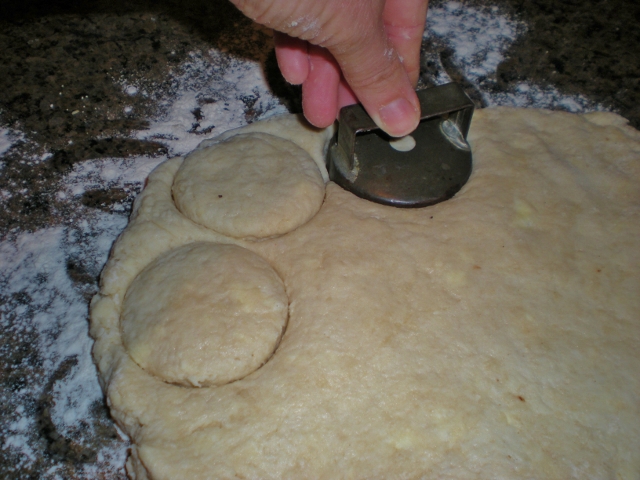Homemade biscuit dough being cut with vintage cutter. #TexasHomesteader