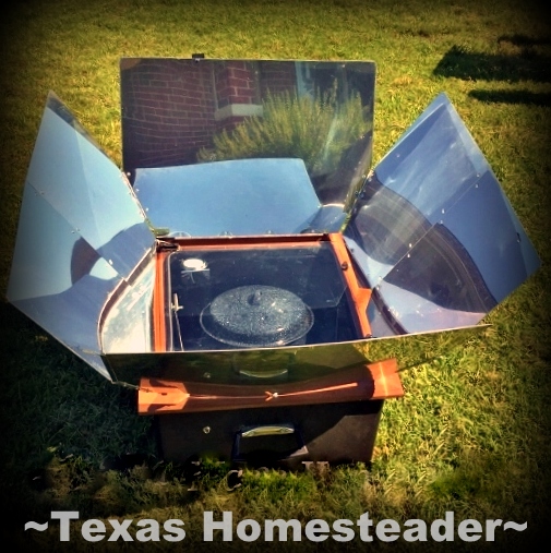 A covered enamel pot cooking food using FREE solar energy in my solar oven. #TexasHomesteader