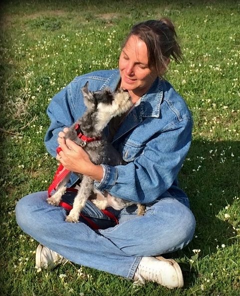 Tammy holding mini-Schnauzer Bailey in her arms.