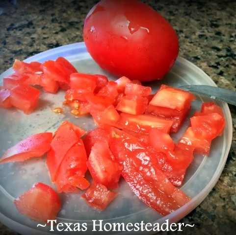 Chopping tomatoes on plastic lid cutting board. This Homestead Hack has 2 benefits when chopping veggies - using something I've already got & keeping juices corralled. #TexasHomesteader