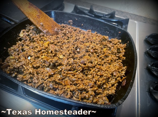 Ground meat and onions cooked in cast iron skillet with homemade taco seasoning mix. #TexasHomesteader