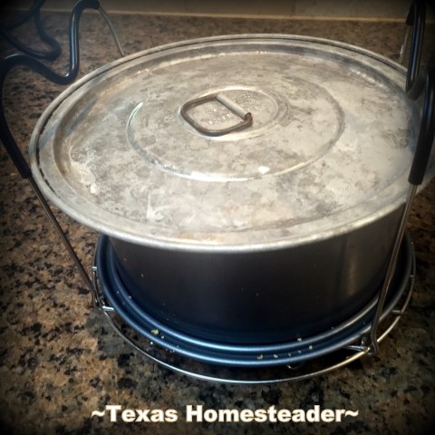 A vintage flat lid on top of a springform pan in a pressure cooker can save single-use foil use. #TexasHomesteader