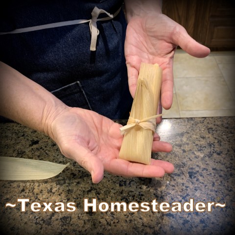 Tying the assembled tamale. It's time consuming to make homemade tamales. But it's very easy. Come see my step-by-step directions complete with photos and recipe. #TexasHomesteader
