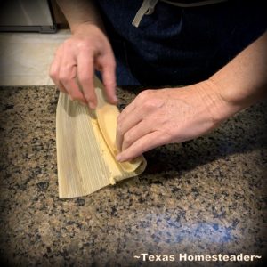 Rolling the tamale. It's time consuming to make homemade tamales. But it's very easy. Come see my step-by-step directions complete with photos and recipe. #TexasHomesteader