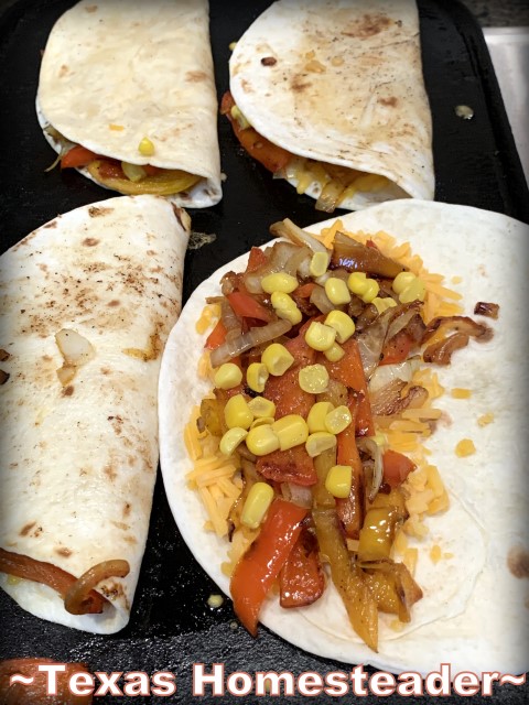 Assembling the Southwest Quesadillas. A quick yet company-worthy meal is Southwest Quesadillas. Freshly grilled veggies, corn & black beans with cheese tucked into a flour tortilla. #TexasHomesteader