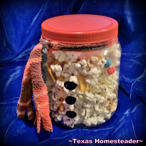 Repurposed large plastic jar filled with Christmas Trail Mix & painted to look like a snowman. #TexasHomesteader