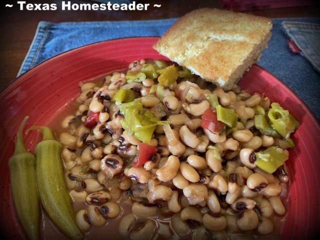 Black eyed peas spicy rotel tomatoes topped with pepperoncini in red bowl with pickled okra and cornbread. #TexasHomesteader