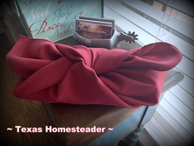 Furoshiki zero-waste eco friendly reusable cloth wrapping for gifts using a red cloth napkin #TexasHomesteader