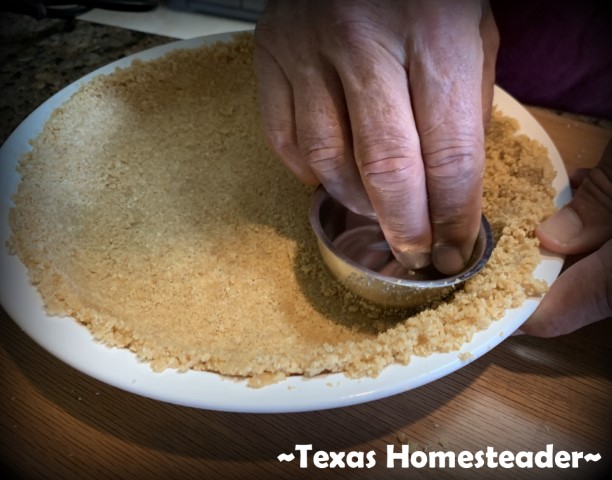 Graham cracker crust - pressing crushed graham crackers, sugar and butter into pie pan for no-bake lemon icebox pie. #TexasHomesteader