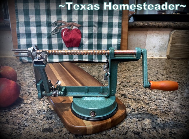 Apple Peeler Corer tool set upon cutting board with green and white kitchen towel in the background. #TexasHomesteader