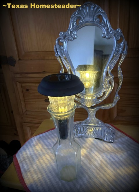 Solar light brought inside in a flower vase with mirror behind for emergency light during power outage. #TexasHomesteader