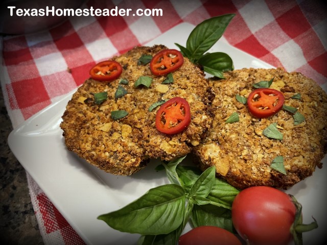 Air fryer salmon patties garnished with fresh basil, red tomatoes and red jalapenos. #TexasHomesteader