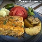 Meat and Cheese stacked Chile Relleno Casserole with sliced tomatoes, jalapenos, cucumbers on blue plate. #TexasHomesteader