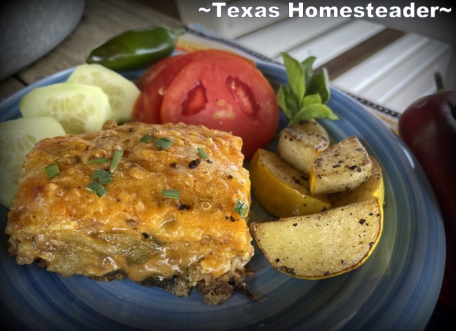 Meat and Cheese stacked Chile Relleno Casserole with sliced tomatoes, jalapenos, cucumbers on blue plate. #TexasHomesteader