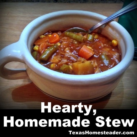 Homemade Beef Stew with potatoes, carrots, green beans and corn in crock bowl with spoon. #TexasHomesteader