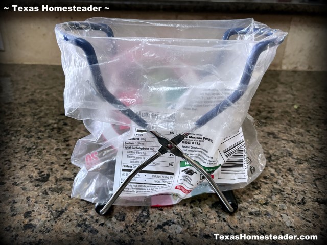 Mason jar canning jar lifter used to hold repurposed plastic bag open for filling with deviled eggs ingredients. #TexasHomesteader