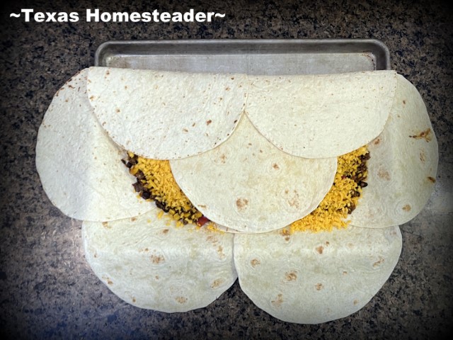 Sheet pan beef quesadilla - fold burrito sized flour tortillas over beef and cheese filling. #TexasHomesteader