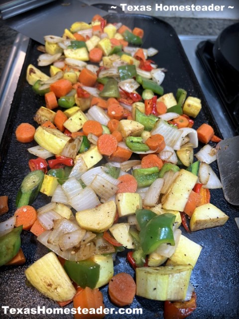 Sauteed garden vegetables on cast iron griddle - green bell pepper, yellow squash, onions. #TexasHomesteader